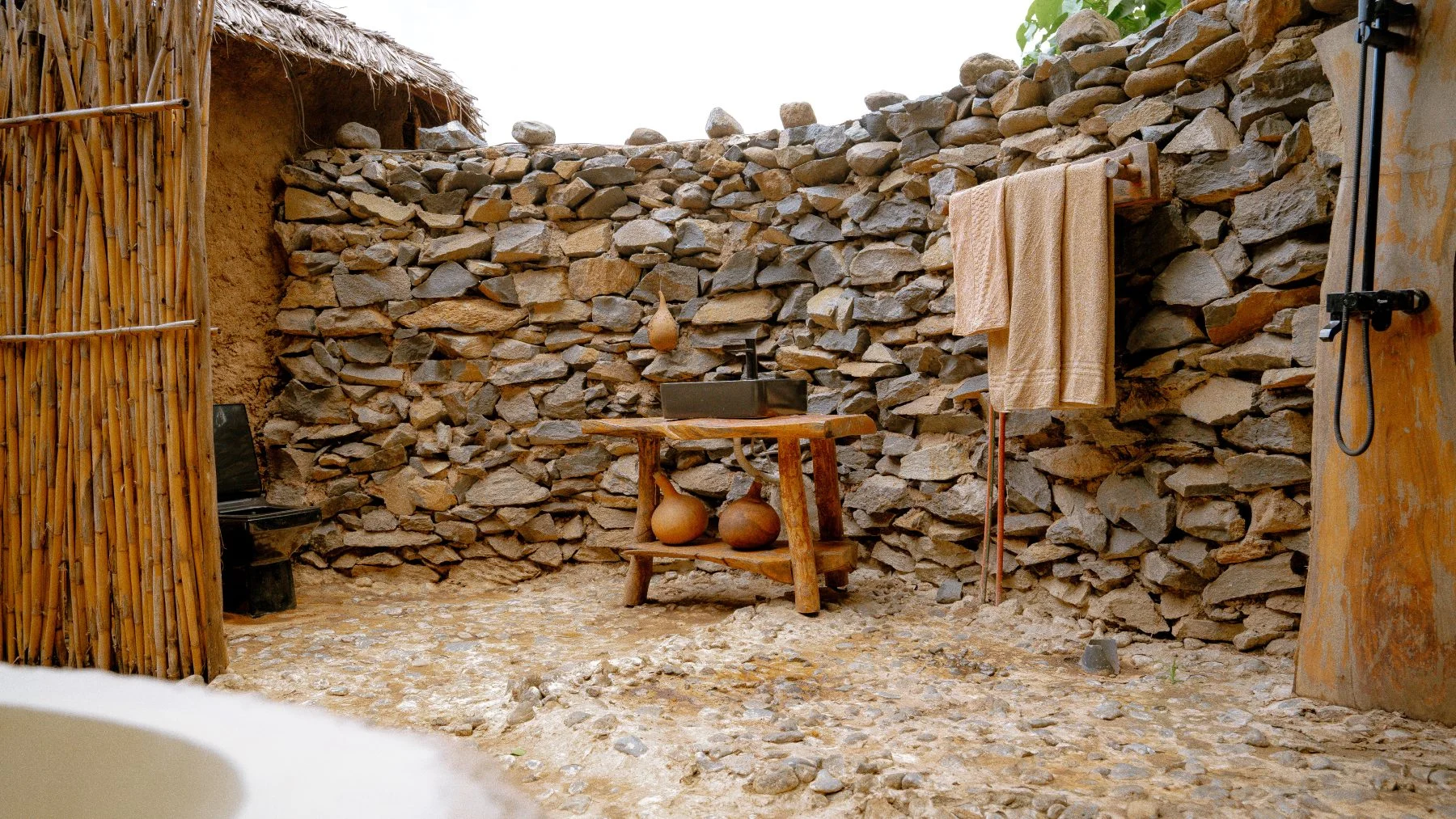 A stone outdoor shower in a guest room at Sio Maasai