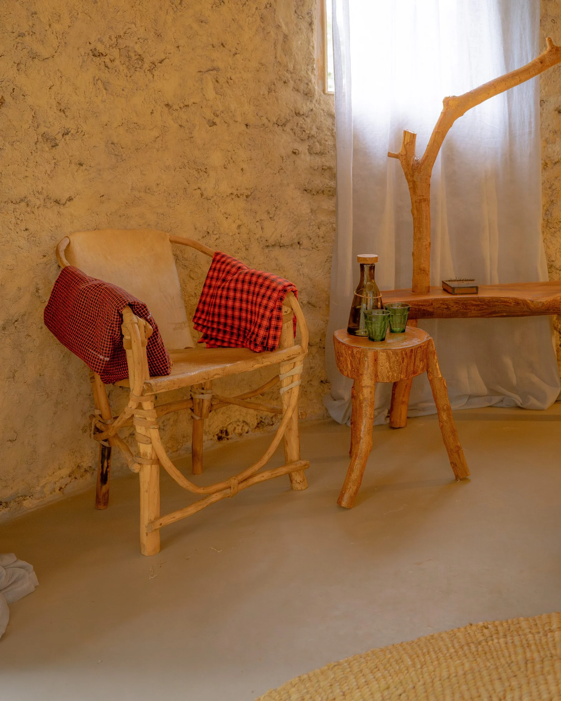 A timber chair in the corner of a guest room at Sio Maasai
