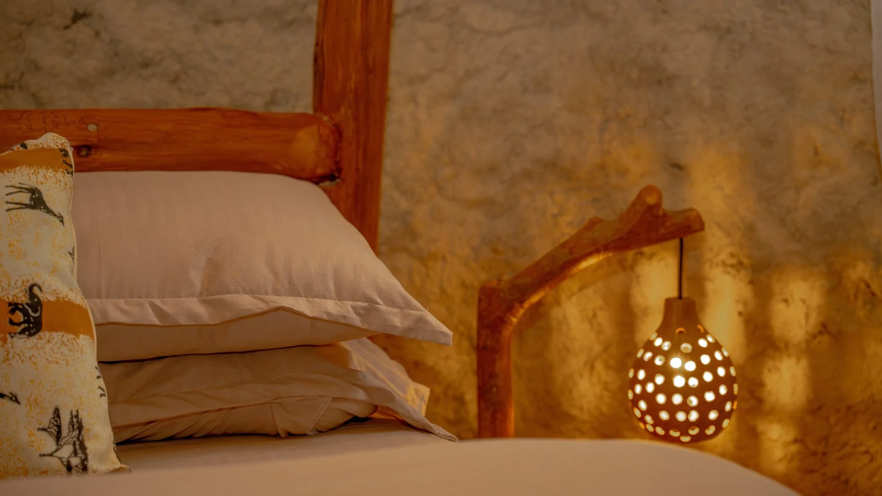 Linen pillows on a bed in a guest room at Sio Maasai